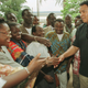 Muhammad Ali shakes hands with fans in Abidjan, Ivory Coast in 1997.